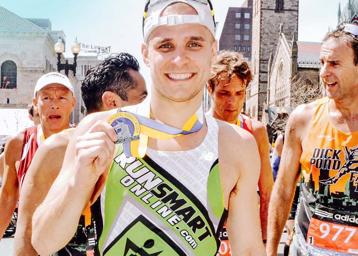 Steve Gonser physical therapist holding medal in marathon